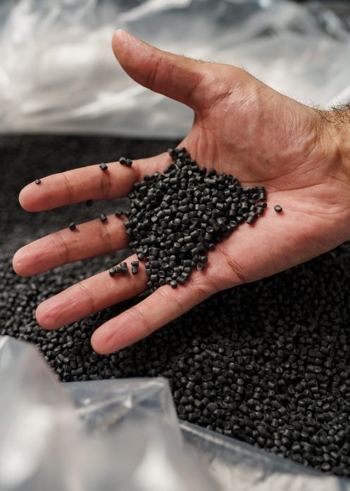 close-up-of-male-hand-holding-plastic-polymer-gran-2023-11-27-05-35-41-utc-min